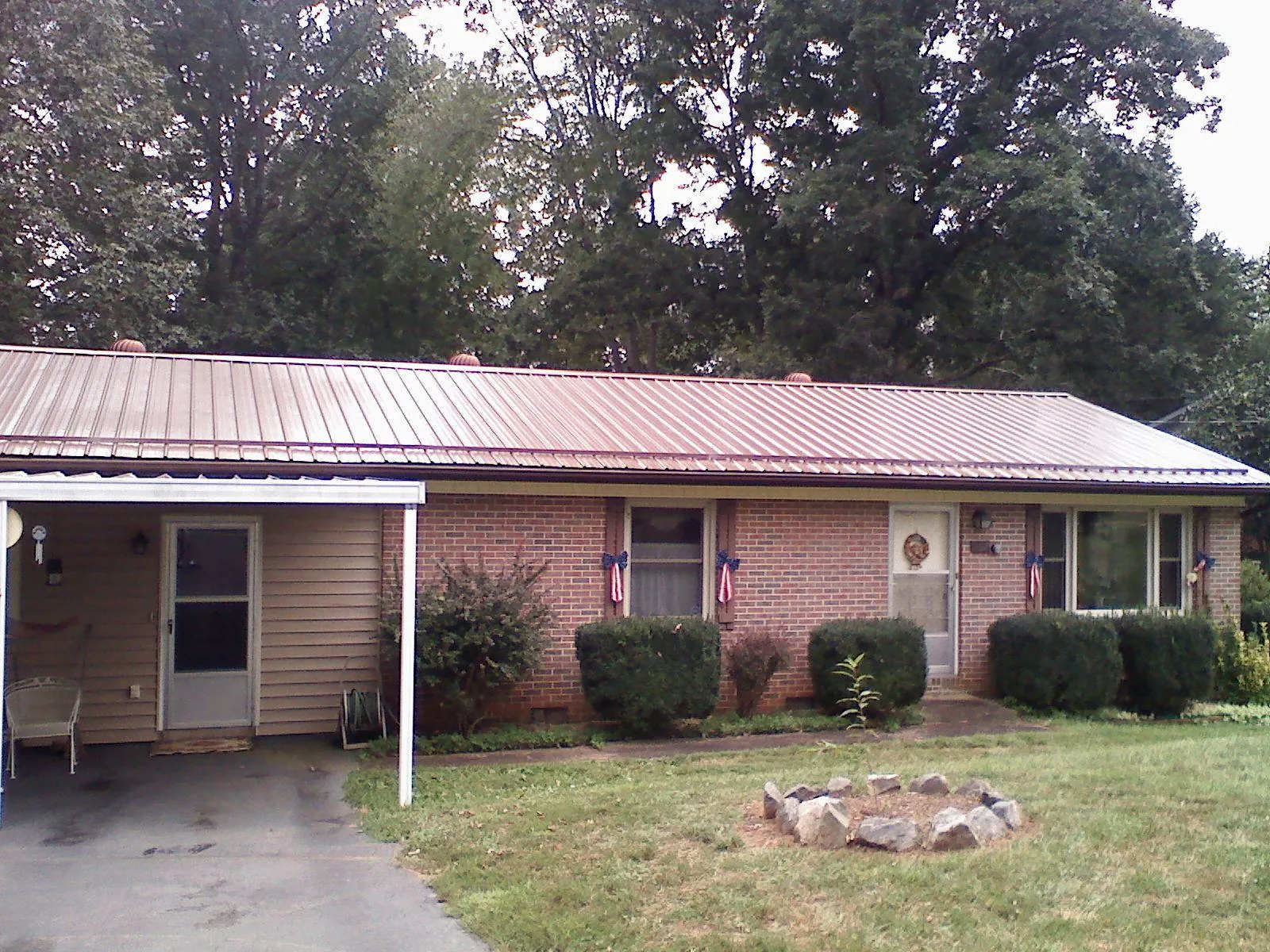 Bronze metal roof and carport on a brick ranch home — Roof Repair work by our crew in Wilmette